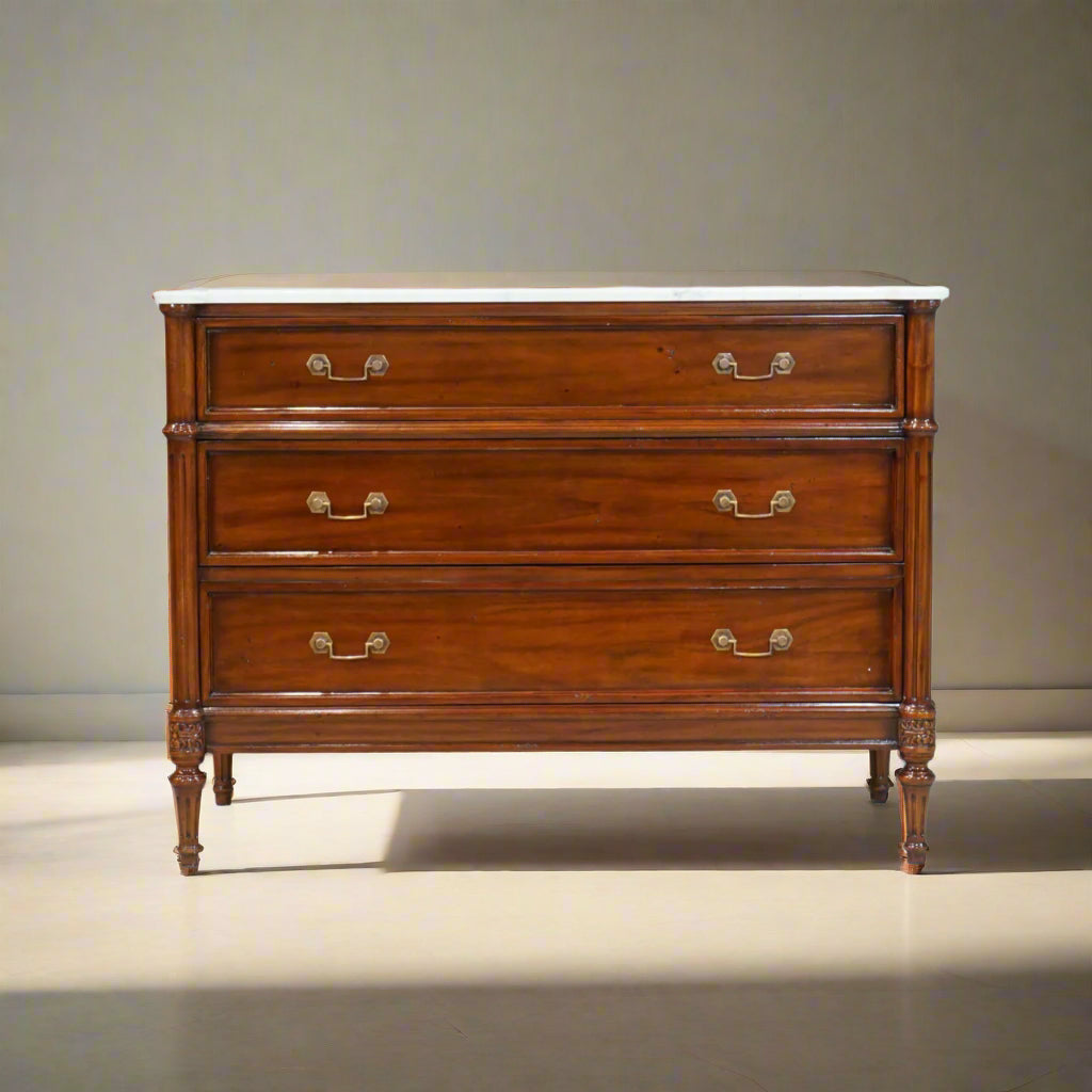Wooden dresser with marble top on a white background
